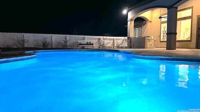 view of pool at night