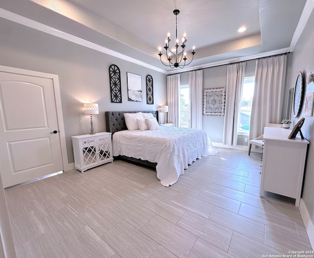 bedroom with a raised ceiling, ornamental molding, and an inviting chandelier