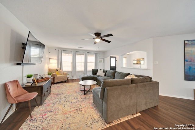 living room with ceiling fan and dark hardwood / wood-style flooring