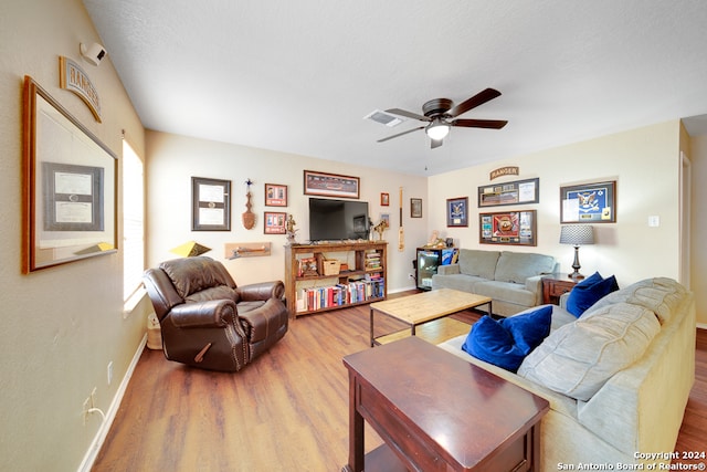 living room featuring a textured ceiling, hardwood / wood-style flooring, and ceiling fan