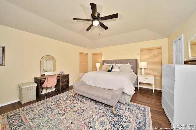 bedroom with dark wood-type flooring, ceiling fan, and lofted ceiling