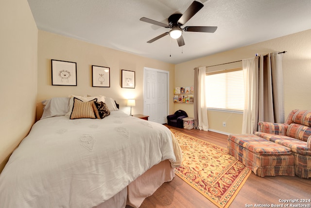 bedroom with wood-type flooring and ceiling fan