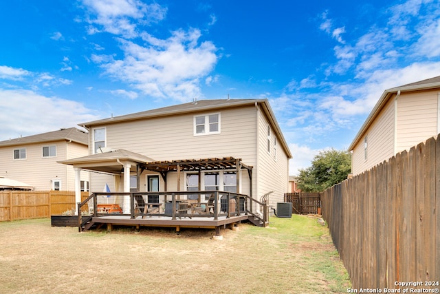 back of house featuring a pergola, a deck, a lawn, and central AC