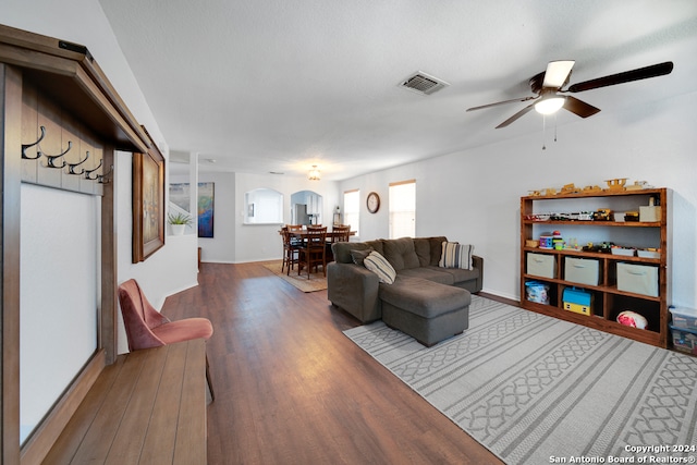 living room featuring hardwood / wood-style floors and ceiling fan