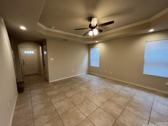 6607 Mia Way, San Antonio, TX 78233 - empty room with a raised ceiling, light tile patterned floors, crown molding, ceiling fan, and arched walkways