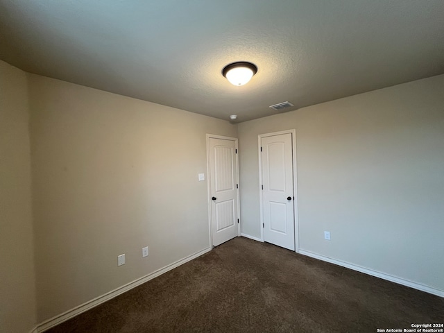 carpeted spare room with a textured ceiling