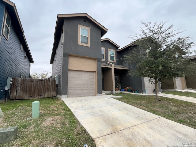 front of property with a front yard and a garage