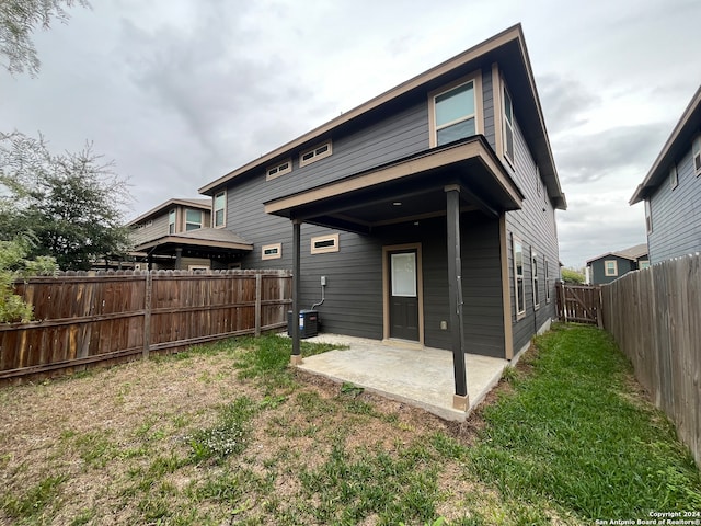 rear view of house with a patio area and a yard