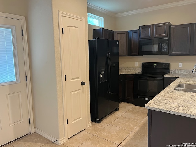 kitchen featuring light stone counters, light tile patterned floors, black appliances, crown molding, and sink