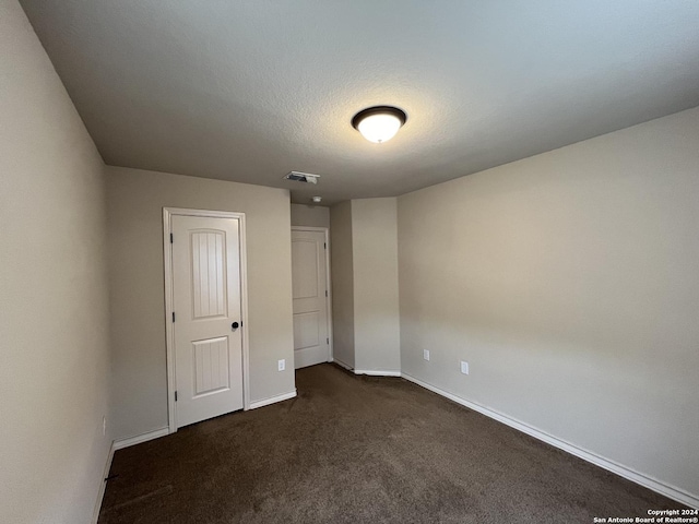 6607 Mia Way, San Antonio, TX 78233 - unfurnished bedroom with baseboards and dark colored carpet