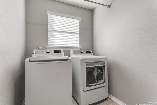 clothes washing area with washing machine and dryer