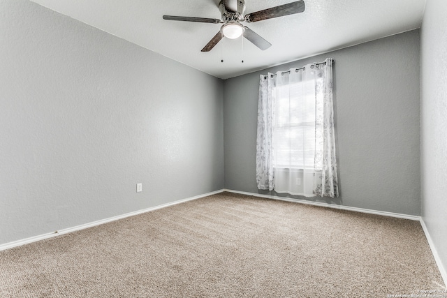 empty room featuring ceiling fan and carpet floors