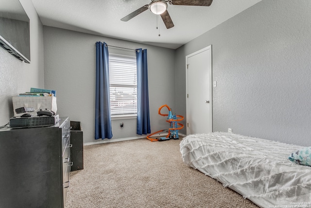 bedroom featuring carpet floors, a textured ceiling, and ceiling fan