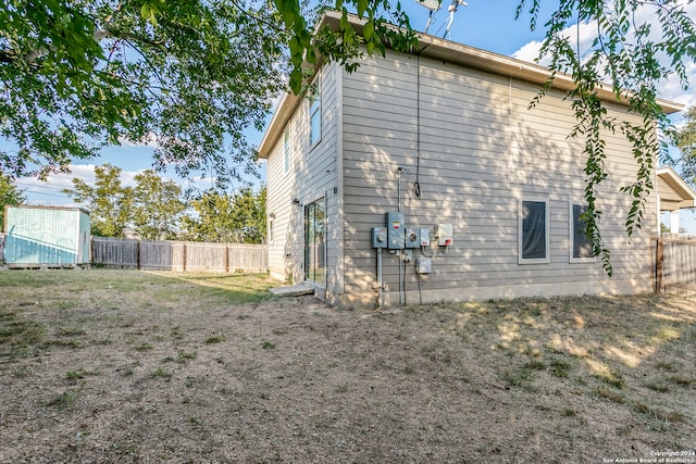 rear view of house featuring a shed