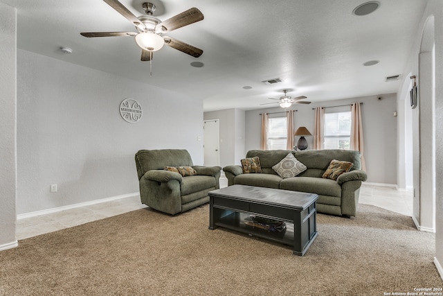 carpeted living room with ceiling fan