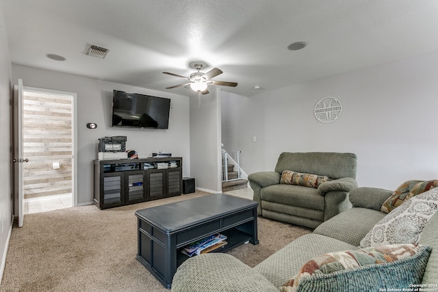 carpeted living room featuring ceiling fan