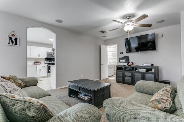 living room featuring light carpet and ceiling fan