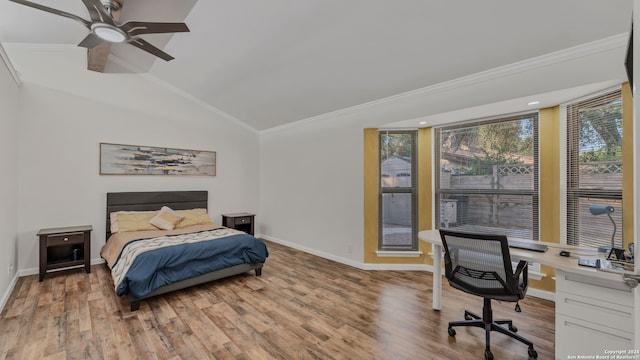 bedroom with ceiling fan, hardwood / wood-style flooring, ornamental molding, and lofted ceiling