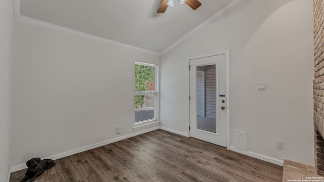 foyer with crown molding, hardwood / wood-style floors, and vaulted ceiling