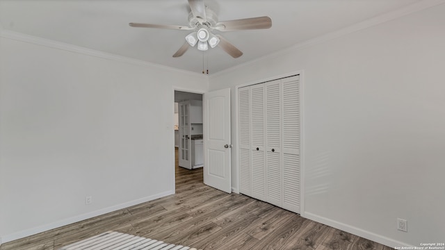 unfurnished bedroom featuring a closet, ceiling fan, ornamental molding, and hardwood / wood-style floors