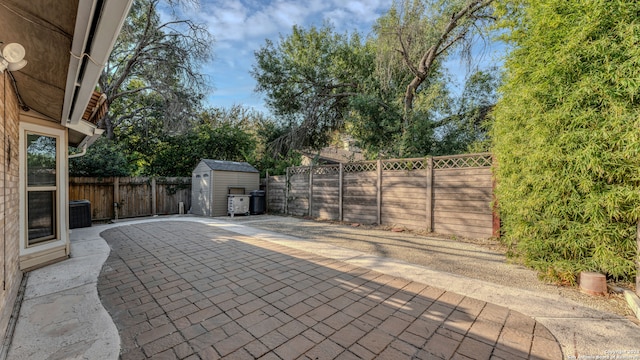 view of patio featuring a storage shed and central AC unit