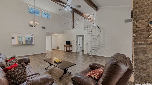 living room featuring beamed ceiling, hardwood / wood-style floors, ceiling fan with notable chandelier, and a high ceiling