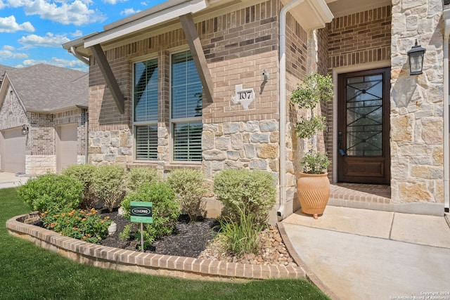 view of exterior entry featuring a garage