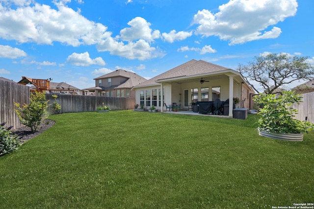 back of property featuring a patio, ceiling fan, and a lawn