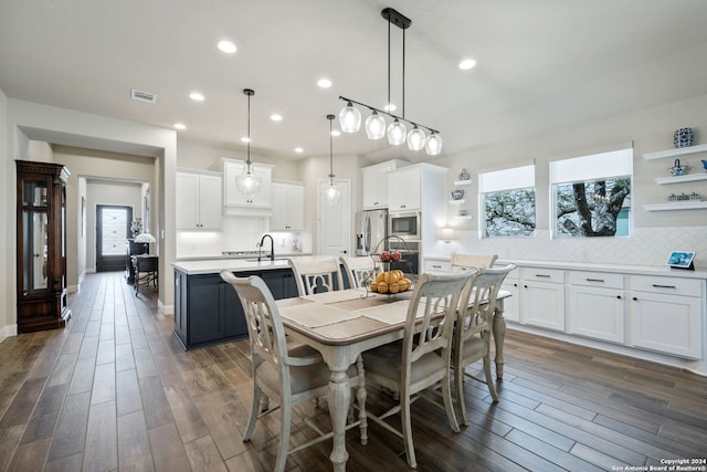 dining space with dark hardwood / wood-style flooring and a wealth of natural light