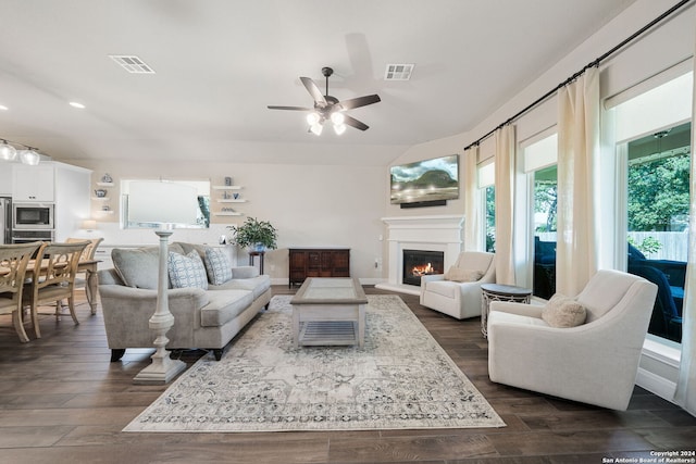 living room featuring dark hardwood / wood-style flooring and ceiling fan