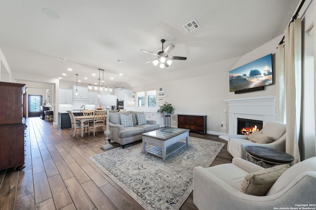 living room featuring dark hardwood / wood-style flooring and ceiling fan