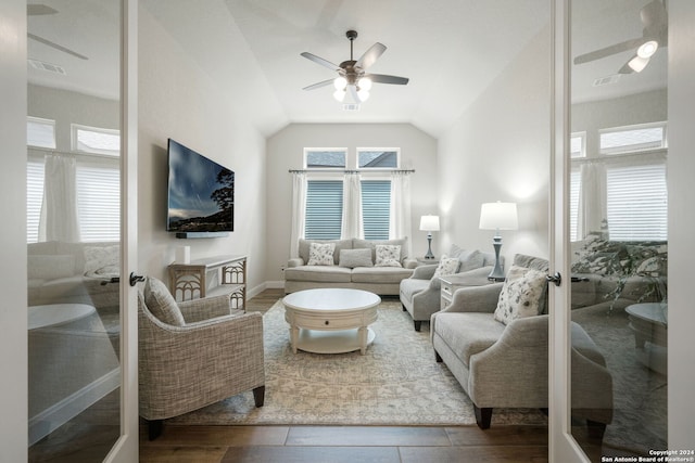 living room featuring ceiling fan, french doors, lofted ceiling, and hardwood / wood-style flooring