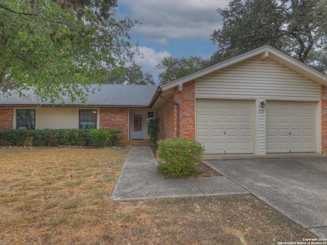 single story home featuring a front yard and a garage