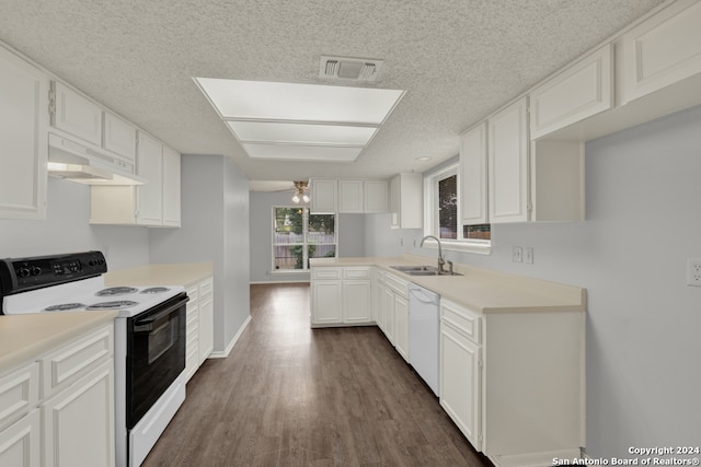 kitchen featuring white appliances, dark wood-type flooring, sink, and white cabinets