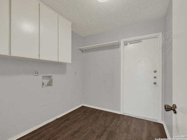 washroom featuring cabinets, a textured ceiling, and dark hardwood / wood-style flooring