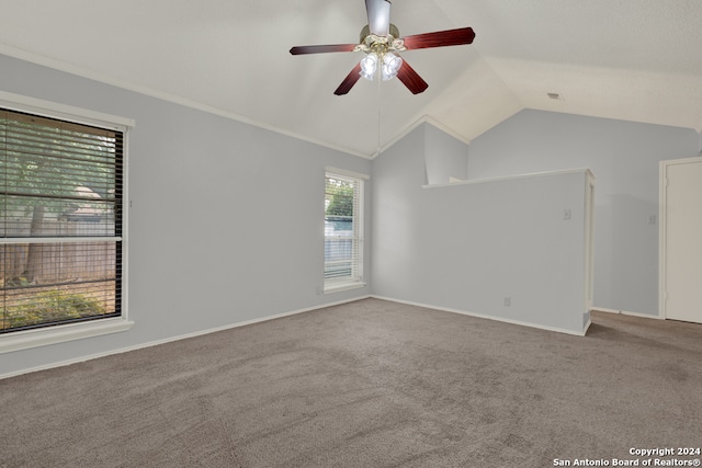 carpeted spare room with lofted ceiling, ceiling fan, and a wealth of natural light