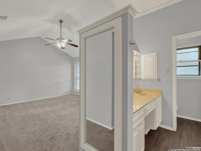 bathroom with vanity, vaulted ceiling, and ceiling fan