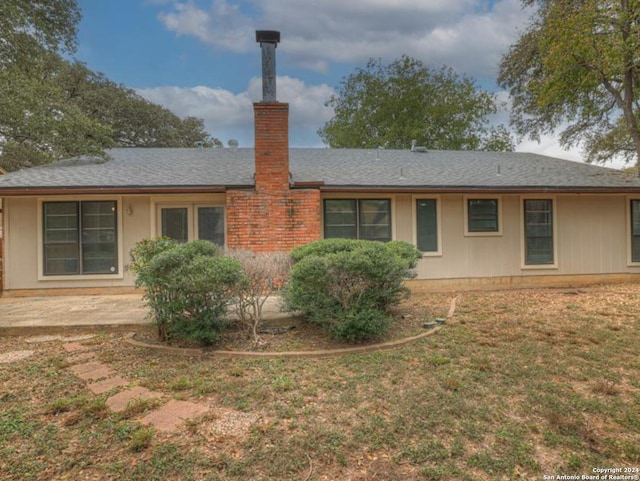 rear view of property with a lawn