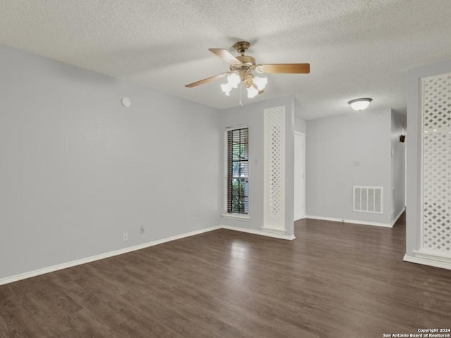 unfurnished room with ceiling fan, a textured ceiling, and dark hardwood / wood-style flooring