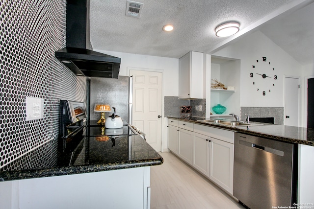 kitchen featuring lofted ceiling, dishwasher, dark stone countertops, ventilation hood, and white cabinets