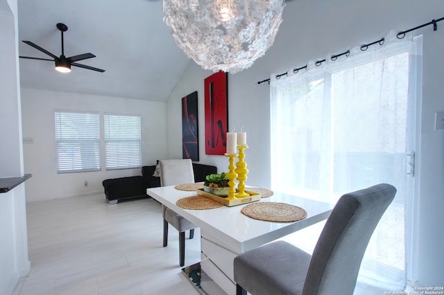 dining area with ceiling fan and vaulted ceiling