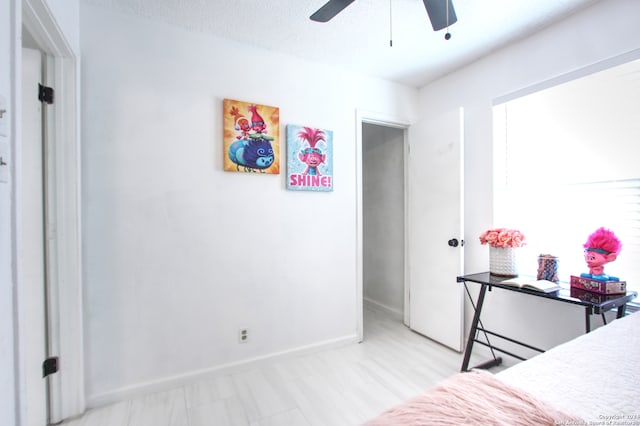 bedroom with a textured ceiling and ceiling fan