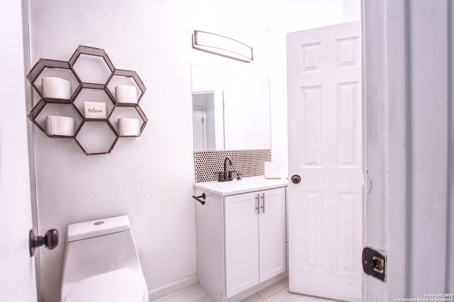 bathroom with vanity, toilet, and tile patterned flooring