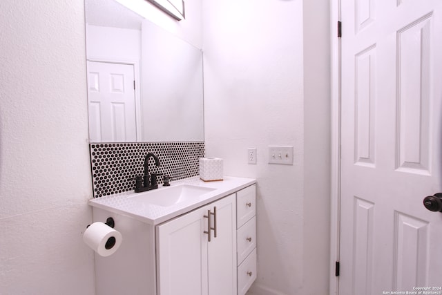 bathroom featuring vanity and decorative backsplash