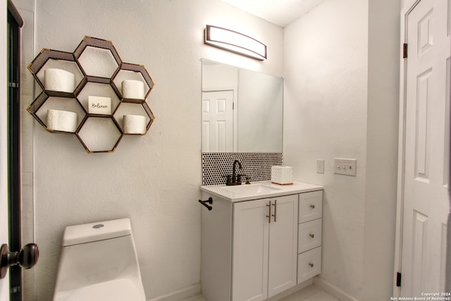 bathroom with toilet and vanity