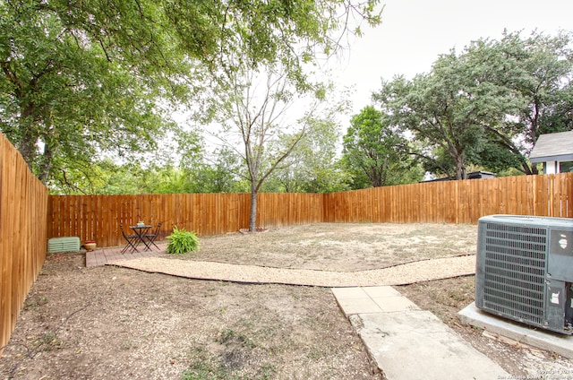 view of yard with cooling unit and a patio area