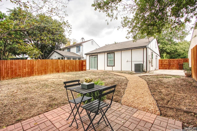 rear view of house featuring a patio area and central AC unit