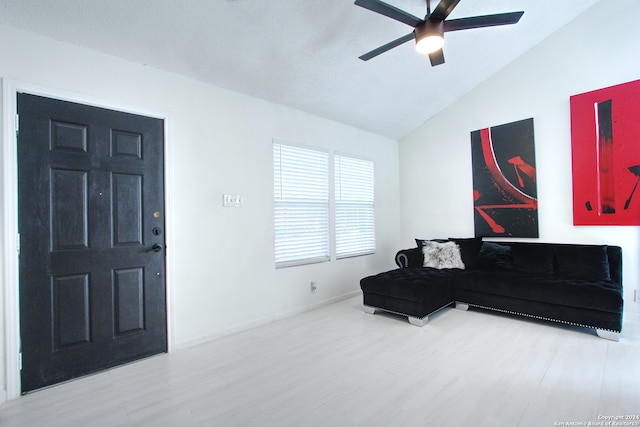 living room featuring lofted ceiling, hardwood / wood-style flooring, and ceiling fan