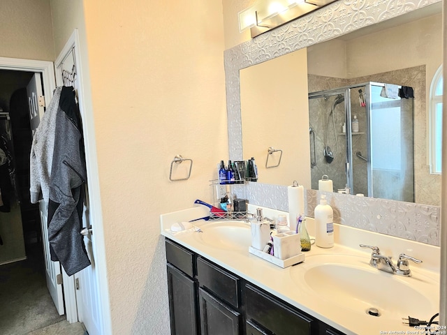 bathroom featuring vanity and an enclosed shower