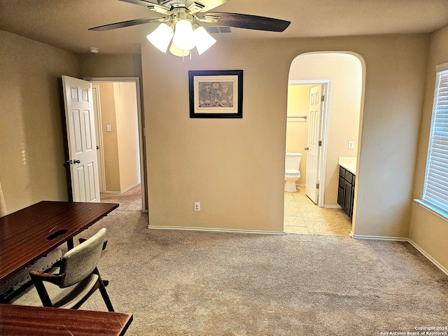 carpeted office featuring ceiling fan